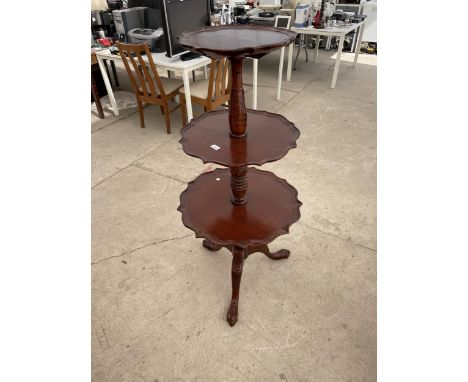 A GEORGIAN STYLE THREE TIER DUMB WAITER ON TRIPOD BASE, CARVED COLUMN AND LION PAW FEET 