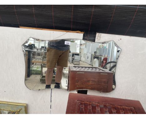 AN ART DECO UNFRAMED BEVELED EDGE MIRROR 
