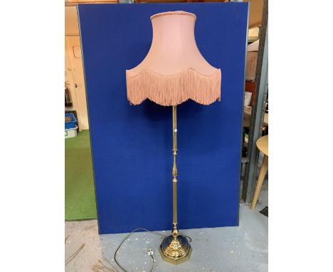 A BRASS STANDARD LAMP WITH PINK SHADE 