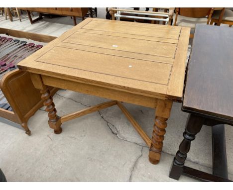 AN EARLY 20TH CENTURY LIGHT OAK DRAW-LEAF DINING TABLE ON BARLEYTWIST LEGS, 42" SQUARE 