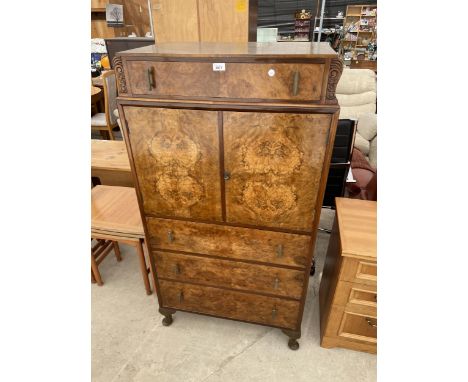AN ART DECO WALNUT TALLBOY ENCLOSING TWO CUPBOARDS AND FOUR DRAWERS, ON CABRIOLE LEGS, 30" WIDE 