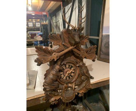 A VINTAGE CUCKOO CLOCK WITH DECORATIVE MOULDING 