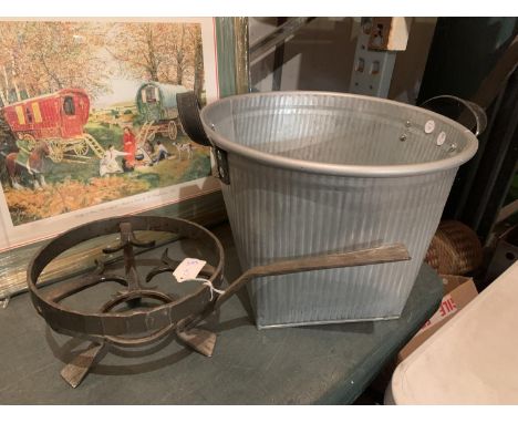 A VINTAGE CAST CAMPING STOVE REST AND A GALVANISED TUB WITH LEATHER STRAPS 