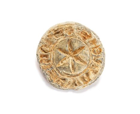 A complete cast lead-alloy personal seal matrix dating to the Medieval period, c. 1200-1300. The matrix is circular in plan, 