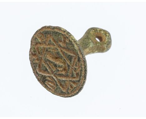 A complete cast copper-alloy seal matrix dating to the Medieval period, c. 1300-1400.The seal is of the so-called pedestal or