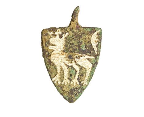 A complete cast copper-alloy and enamel heraldic harness pendant dating to the Medieval period, c. 1200-1400. The pendant is 