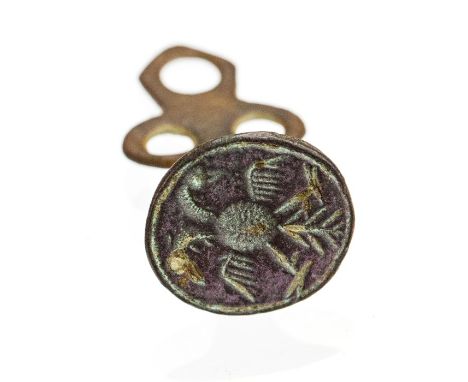 A complete cast copper-alloy pedestal type impersonal seal matrix dating to the Post-Medieval period, c. 17th century. The se