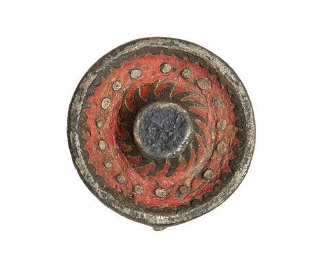 An incomplete cast copper-alloy and enamel disc brooch dating to the Roman period, c. AD 100-200. It is circular in plan, wit