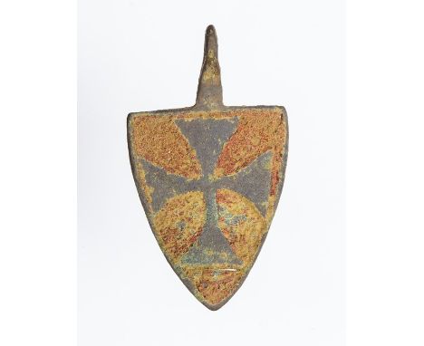 A complete cast copper-alloy and enamel heraldic harness pendant dating to the Medieval period, c. 1200-1400. The pendant is 