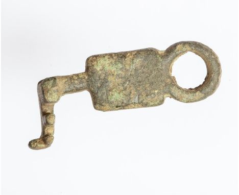 A complete cast copper-alloy tumbler lock slide key dating to the Roman period, c. AD 43-410. The object consists a circular 