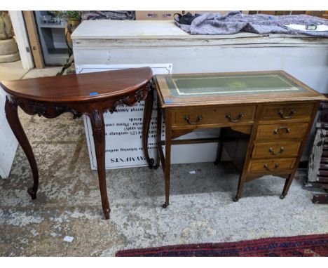 An early 20th century inlaid walnut knee hole desk, the top with gilt tooled inset green leather scriber, over one long and o