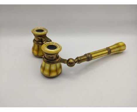 Early 20th century French yellow mother of pearl opera glasses, retailed by H C Abbott & Bro, Birmingham, with engraved ornam