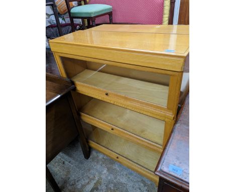 A light oak three-section Globe Wernicker 111cm x 85cm x 28cm Location: G 