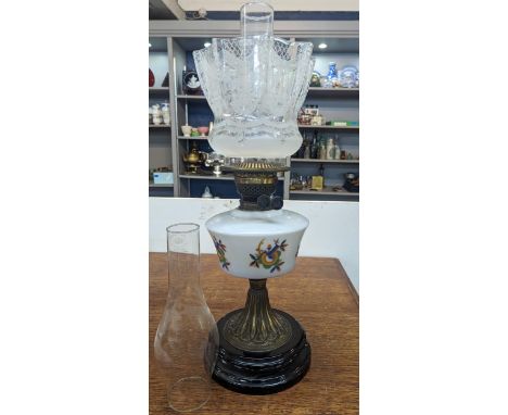 A vintage brass oil lamp having floral decorated glass shade and decorated glass rostrum Location: 