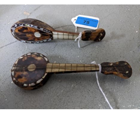 Two Continental inlaid tortoiseshell and mother of pearl model banjo/ukulele musical instruments Location: 