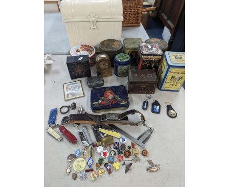 A collection of vintage tins to include tea caddy tins, sweets and others, together with enamel and pin badges, Girl Guides b