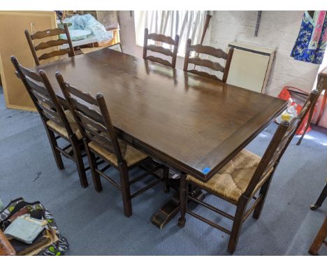 A reproduction oak refectory style dining table and six ladder back chairs, 76cm h x 183cm wLocation: 