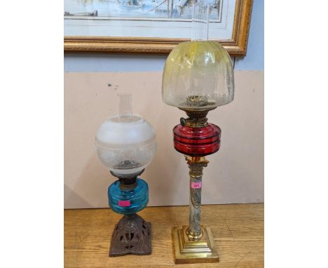 A Victorian brass and agate pottery Duplex oil lamp with etched shade, and a Victorian cast iron oil lamp with blue glass res
