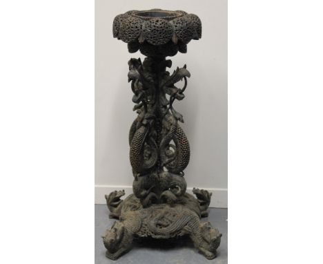 AN INDO-BURMESE CARVED HARDWOOD PLANTER, the circular top carved and pierced with foliate designs around a circular well, the