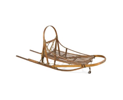 Early to mid-20th century wooden bentwood racing style dog sled. With beaded thunderbird design along the brush bow.Height: 3