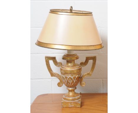 A gilt table lamp in the form of a twin handled urn with gilt oval section shade, height 75cm.
Note: This is a 110/120 volt a