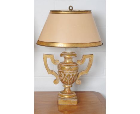 A gilt table lamp in the form of a twin handled urn with gilt oval section shade, height 75cm.
Note: This is a 110/120 volt a