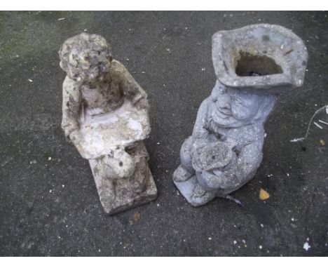 TWO CONCRETE GARDEN ORNAMENTS TO INCLUDE A CONCRETE TOBY JUG PLANTER BOY READING STATUE