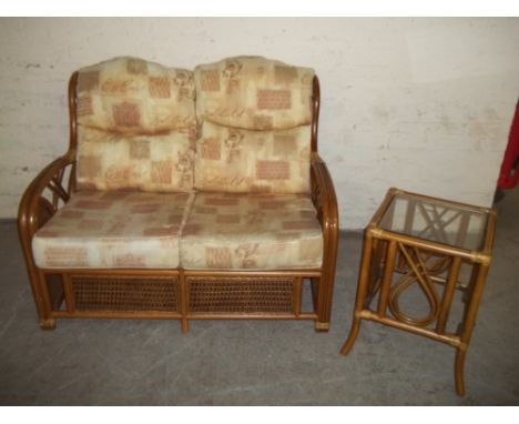 A WICKER TWO SEATER SOFA AND SMALL SIDE TABLE