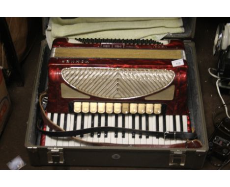 A CASED VERDI ACCORDION 