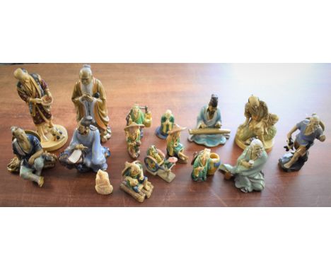 Chinese and Japanese ceramic figurines (16) depicting many figures working. A nice collection, mostly glazed and come based m