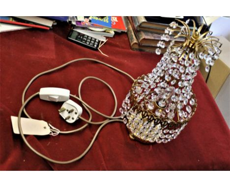 An vintage brass lamp with hanging crystal drop chandelier design, measures 14 1/2" by 6 3/4". 