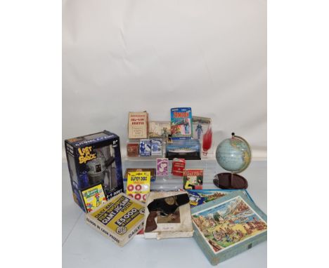 A mixed lot of assorted toys, including Lost in Space B-9 Robot, tinplate globe, an Indiana Jones cap gun, a quantity of cloc