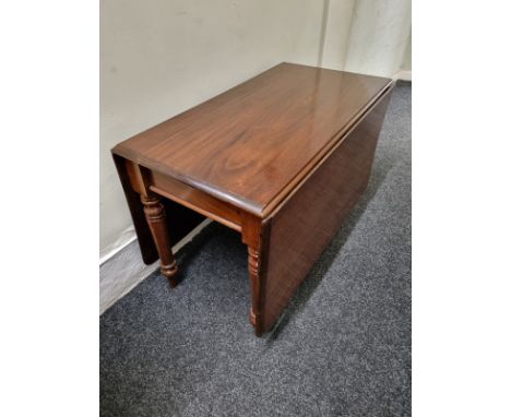 A rectangular mahogany drop leaf gate leg table, having turned legs and shaped supports, 70cm high x 164cm extended x 104cm