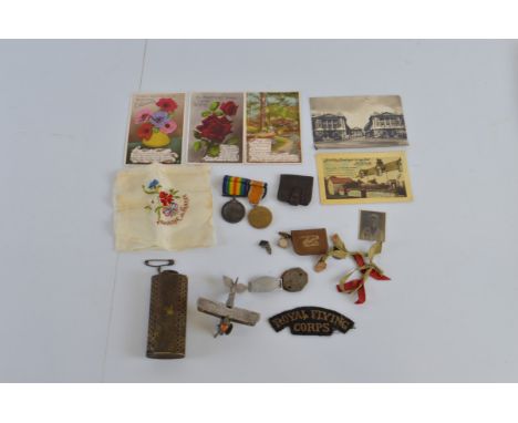 A collection of WW1 memorabilia, including a WW1 medal pair named 29273. A. M. G. Knight. R. F. C., an ID bracelet and tags, 