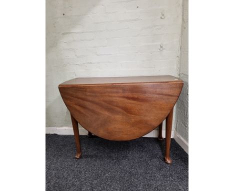 An oval mahogany drop leaf gate leg table,  on pad feet, 130cm extended