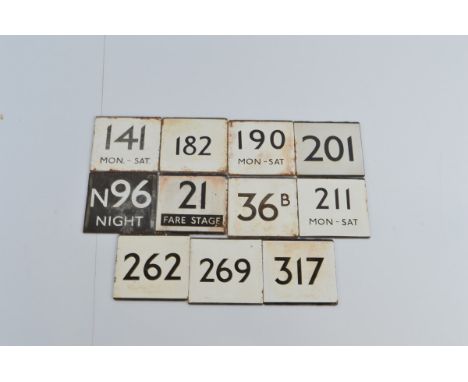 Eleven vintage London Transport 'E' plates from various routes, these metal signs, with usually a white enamel coating and bl