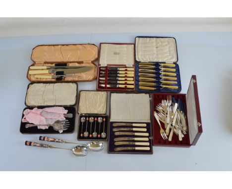 A quantity of early 20th Century boxed cutlery sets, including coffee spoon sets, carving sets, etc. Together with a quantity