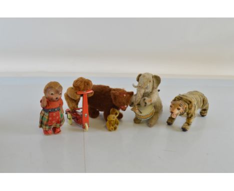 A collection of tinplate clockwork animal toys, including Marx Tiger, Judenbach muzzled Bear, a miniature Schuco Bear, Circus