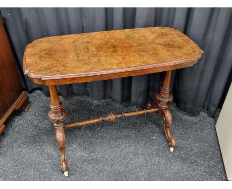 A Victorian walnut oval sofa table, the moulded satinwood, quarter veneered inlaid top, supported on turned and carved suppor