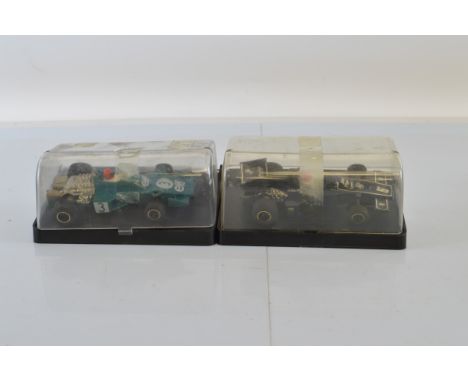 Two Scalextric slot cars, Tyrrell C121-010 and John Player Special C126, both with plastic cases (2)