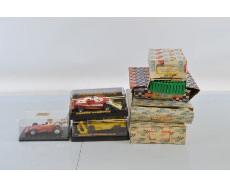 A quantity of Scalextric, including boxed cars (motors missing), together with a quantity of boxed track.