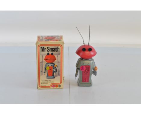 Marx Toys Mr Smash toy, clockwork walking Smash Martian No. 5468, with box and antenna.