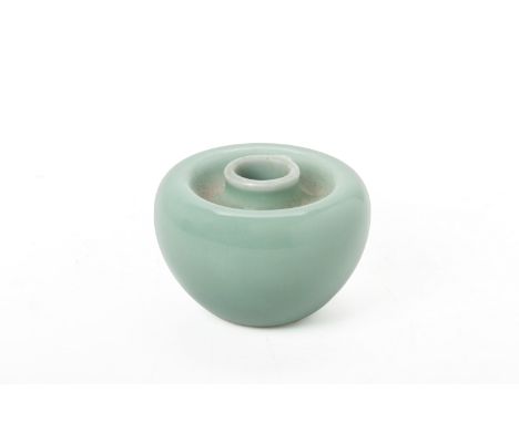 AN APPLE FORM PORCELAIN WATER POT
The rounded body with a channel around the short neck, covered in a celadon coloured glaze,