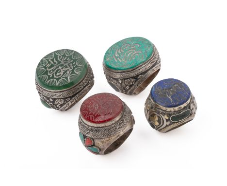 FOUR LARGE ISLAMIC INTAGLIO SEAL RINGS
Three carved with Islamic script seal, within a stylised border, one carved with a hon