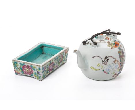 A FAMILLE ROSE TEAPOT AND RECTANGULAR DISH
The teapot decorated with precious objects on a white ground, iron red seal mark t
