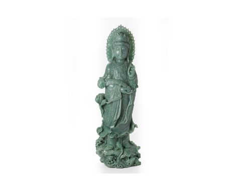 A LARGE CARVED JADE MODEL OF GUANYIN
Modelled standing on a lotus base and holding a ruyi sceptre in one hand and a pearl in 