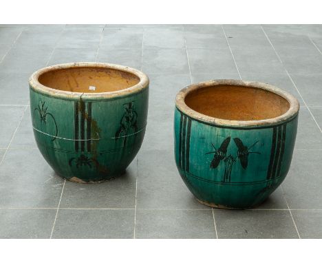 TWO SIMILAR GREEN GLAZED CERAMIC PLANTERS
Decorated with floral motifs (large crack to one planter, the other also with crack
