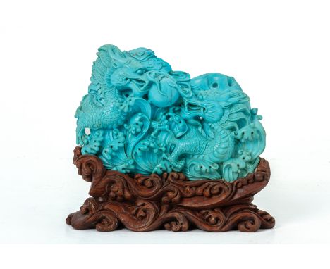 A CHINESE TURQUOISE CARVING OF DRAGONS
Carved in the round with two dragons flanking a central pearl, amongst clouds and cras
