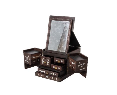 A MOTHER OF PEARL INLAID HARDWOOD VANITY BOX
With hinged cover and out folding front, the interior with an arrangement of sma