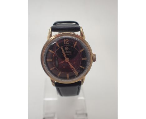 Yellow metal Zodiac Autographic black faced gents wristwatch with leather strap and unusual winding progress mechanism CONDIT